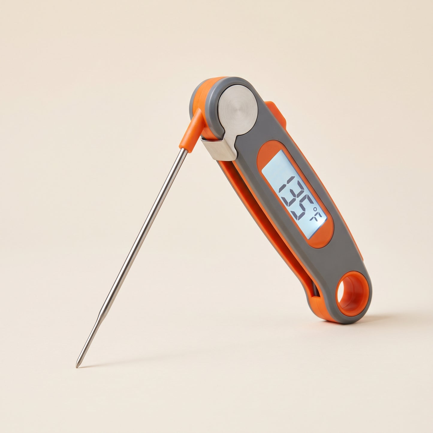 Folding instant-read digital thermometer with orange accents and backlit display