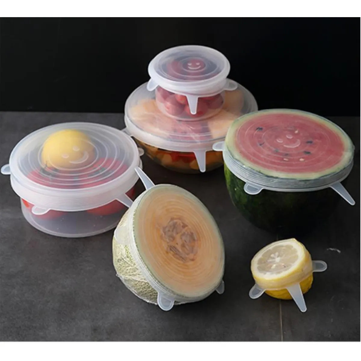 Silicone stretch lids in six sizes sealing bowls, a melon half and a watermelon