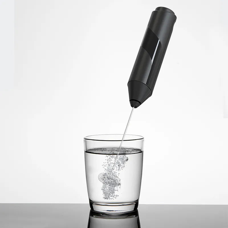 Electric milk frother whisking milk foam