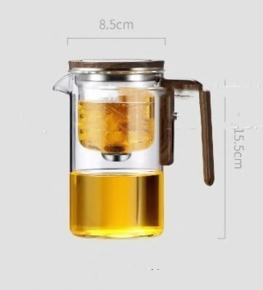 Glass brew teapot on a table with tea
